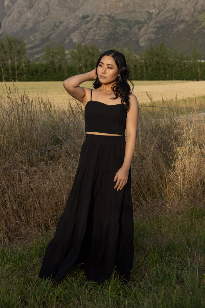 Black Just For Jane tiered cotton maxi skirt shown from front angle