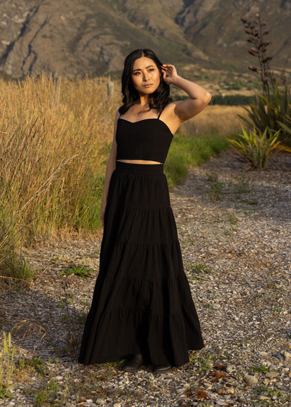 Black Just For Jane tiered cotton maxi skirt shown from side angle